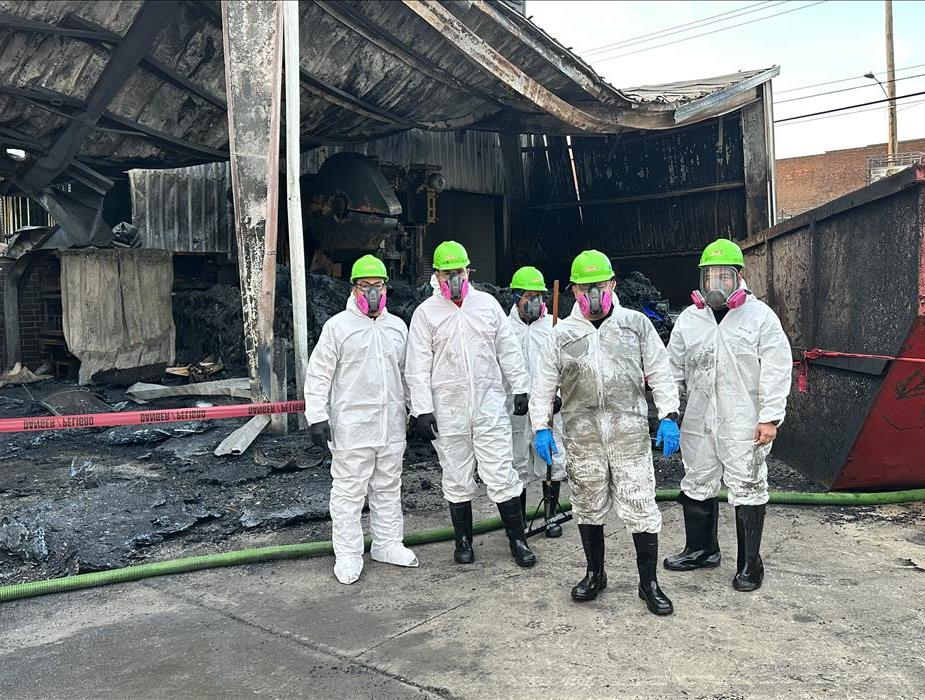 SERVPRO technicians in front of a burned down commercial structure