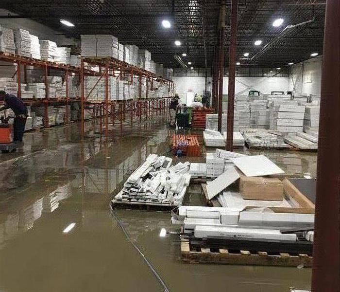 A warehouse floor covered in water from a flood